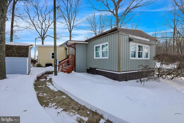 a backyard of a house with fire pit and chairs