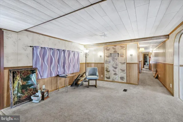 a view of a room with lots of furniture and a window