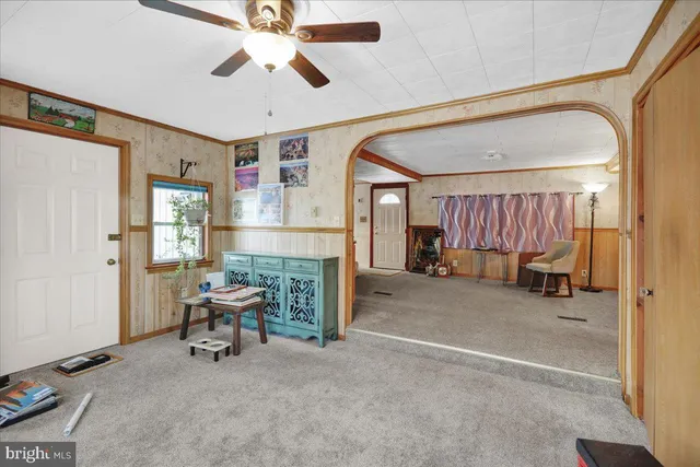 a view of a livingroom with furniture and a ceiling fan