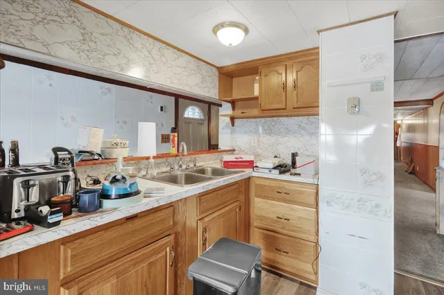 a kitchen with a sink cabinets and appliances