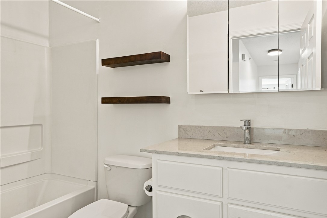 636 Lookover Drive Anderson, SC 29621 - Photo 16 of 34 Clean lines and a stone-topped vanity define this modern bathroom space.