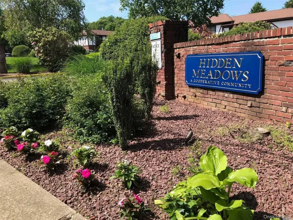 a sign that is in front of flowers