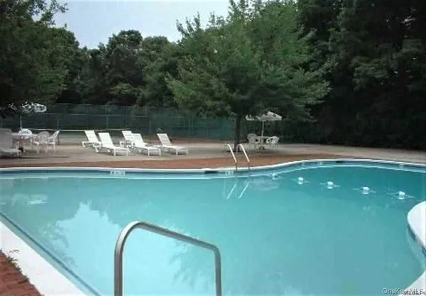 a view of a swimming pool with a yard