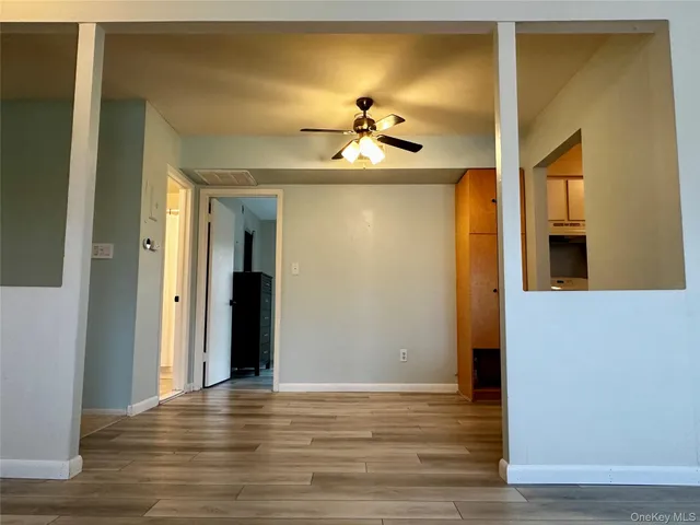 a view of a room with wooden floor and cabinet