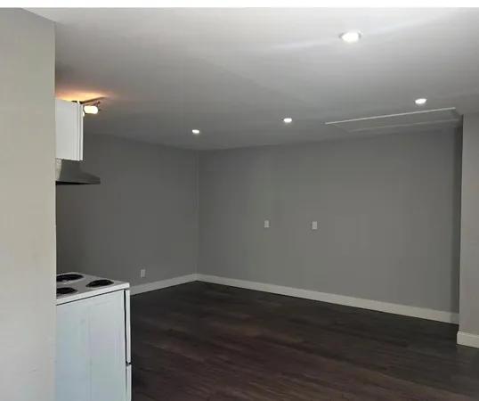 a view of a room with wooden floor