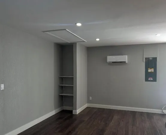 an empty room with wooden floor and closet
