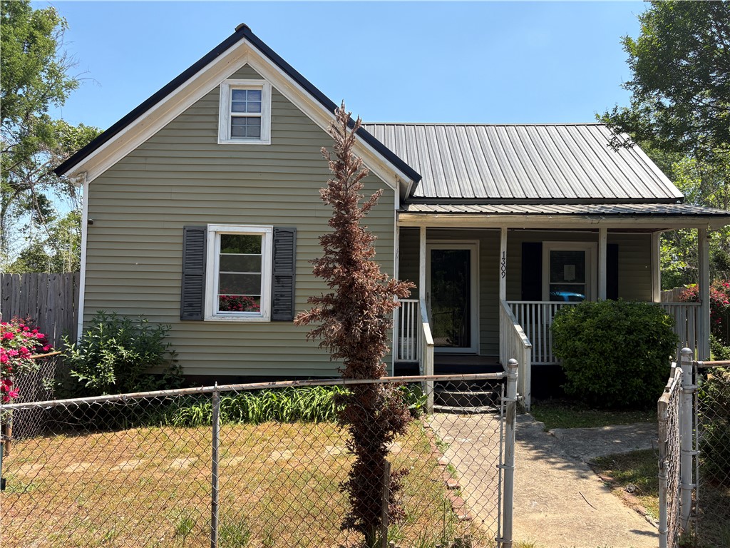 1309 Gilmer Street Anderson, SC 29621 - Photo 7 of 15 Charming home featuring durable metal roofing and classic shuttered windows.