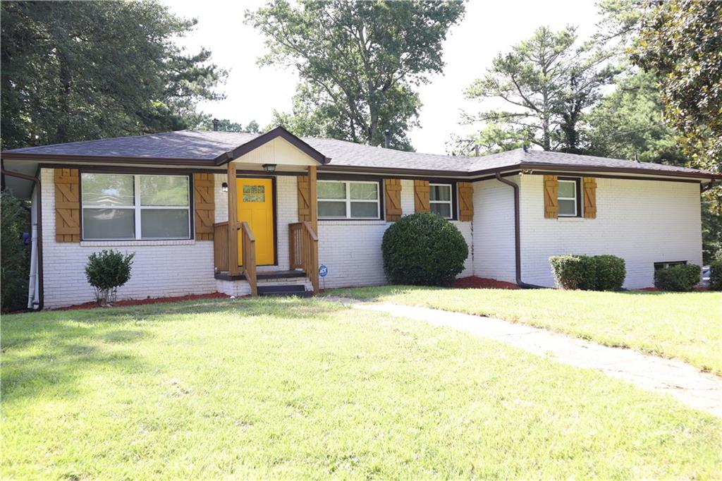 481 Dollar Mill Road Southwest Atlanta, GA 30331 - Photo 1 of 1 a front view of a house with a yard and garage
