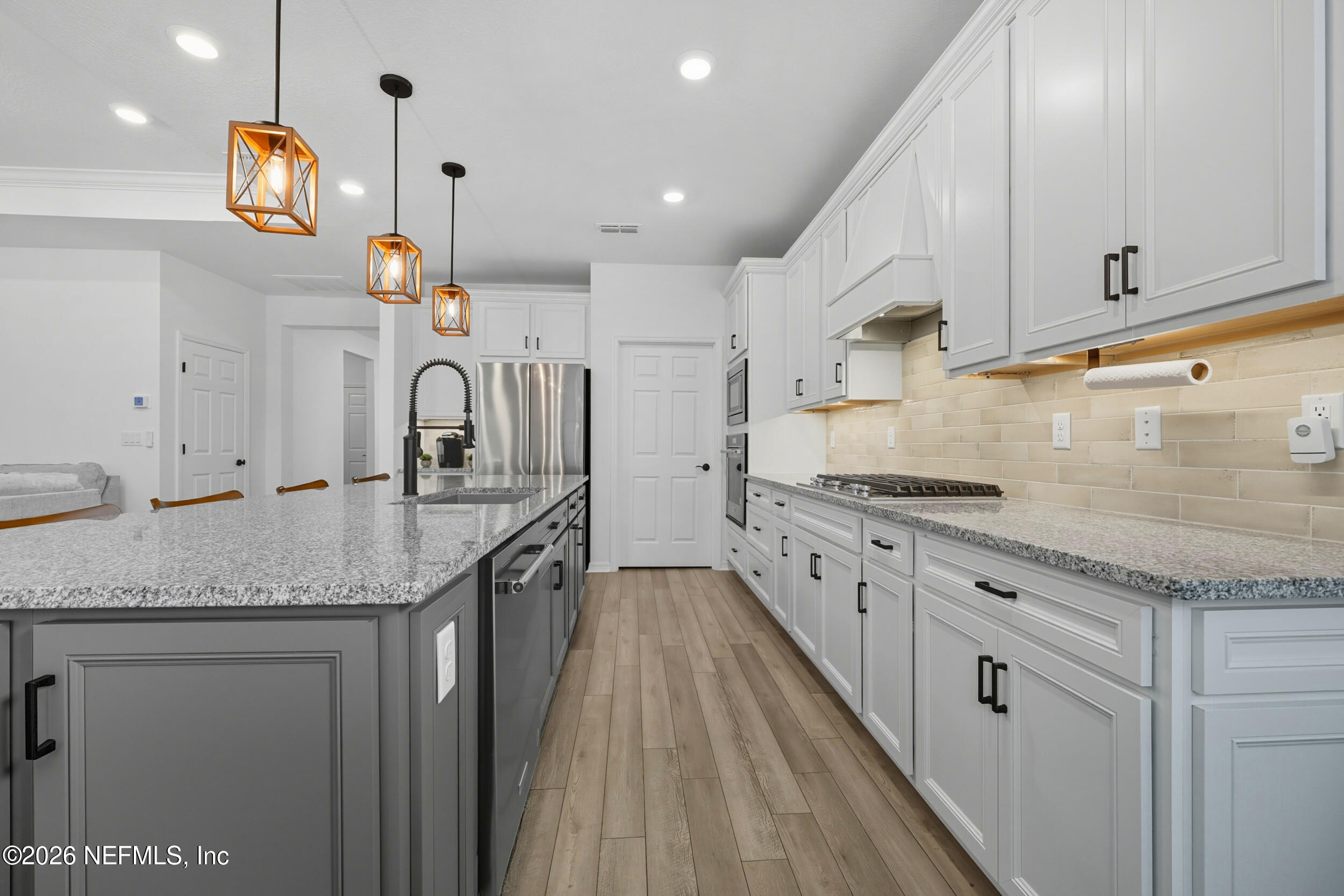 145 Lone Cypress Way St. Augustine, FL 32092 - Photo 12 of 56 a kitchen with granite countertop a sink a counter space and cabinets