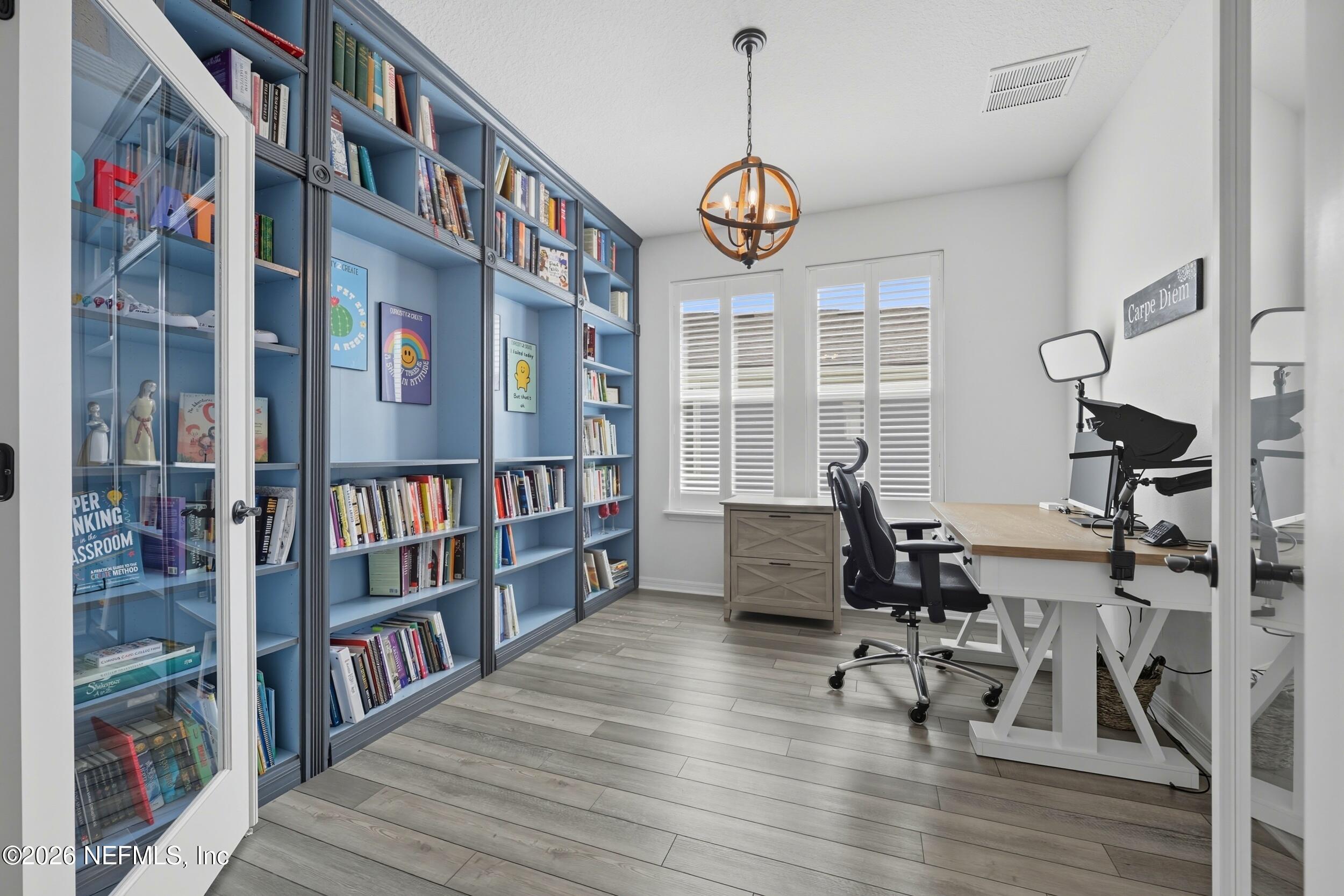145 Lone Cypress Way St. Augustine, FL 32092 - Photo 31 of 56 a view of a livingroom with furniture bookshelf and a window