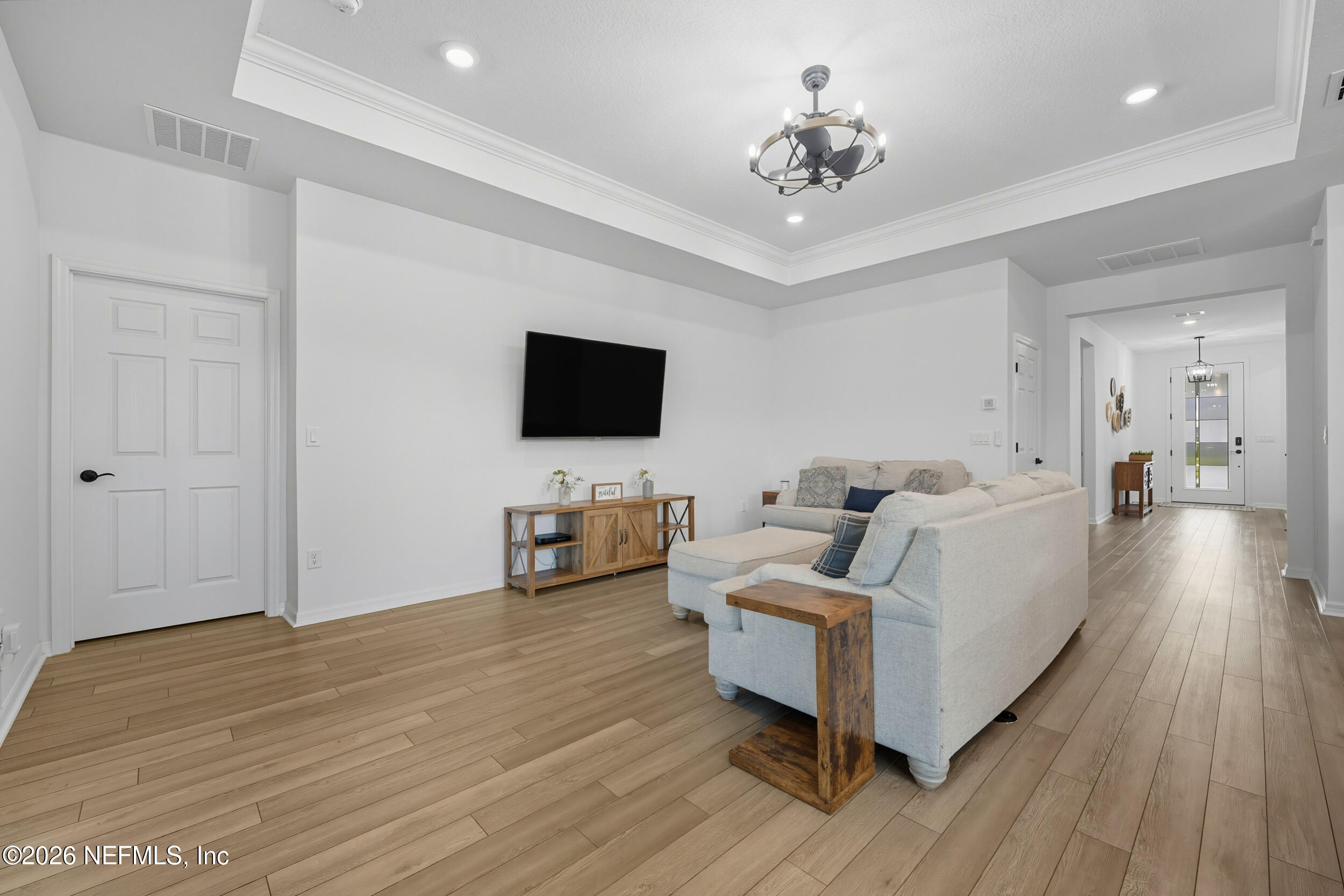 145 Lone Cypress Way St. Augustine, FL 32092 - Photo 6 of 56 a living room with furniture and a flat screen tv