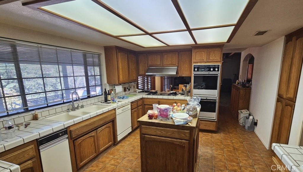 4011 Alta Vista Drive Fallbrook, CA 92028 - Photo 14 of 27 a kitchen with stainless steel appliances granite countertop a sink stove and cabinets