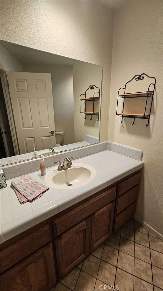 4011 Alta Vista Drive Fallbrook, CA 92028 - Photo 16 of 27 a bathroom with a sink a vanity and mirror