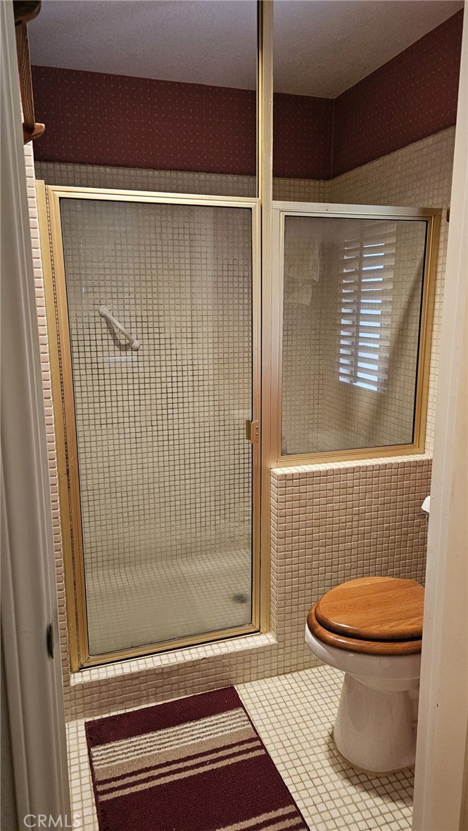 4011 Alta Vista Drive Fallbrook, CA 92028 - Photo 22 of 27 a bathroom with a toilet and a shower