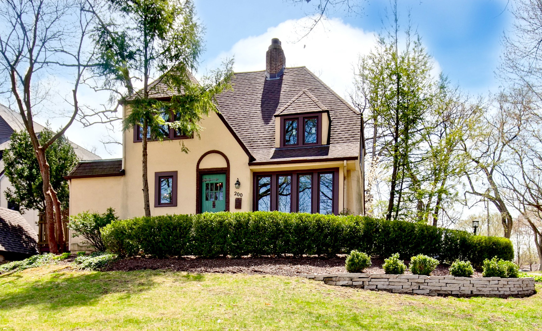 a front view of a house with swimming pool having outdoor seating