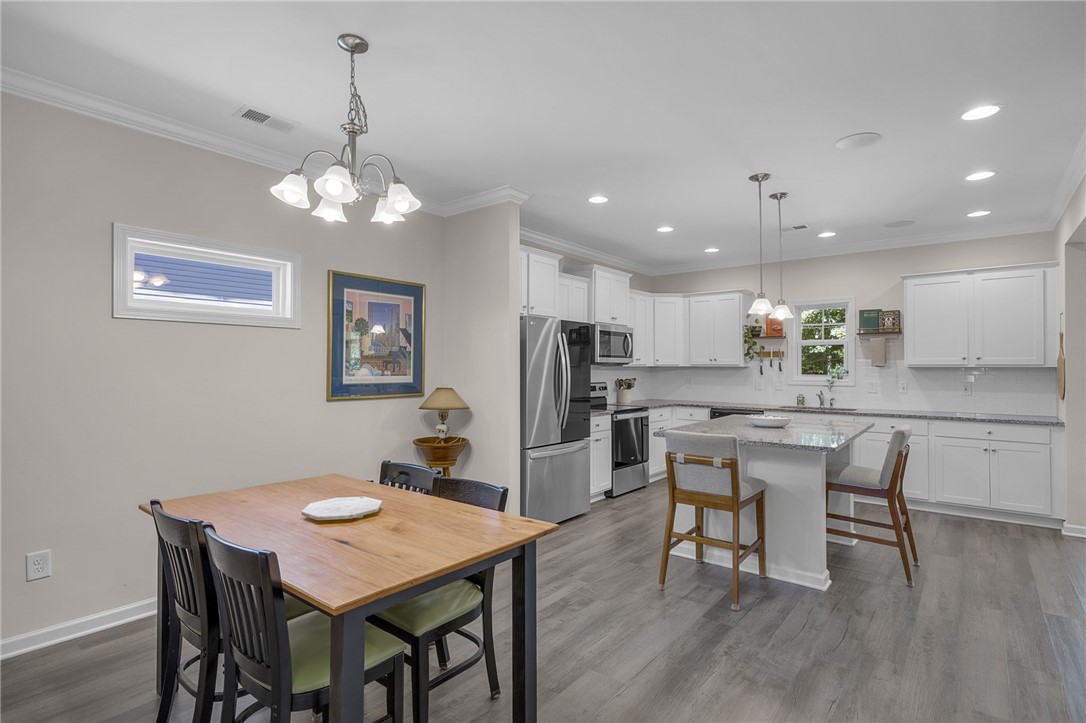 430 Johnson Road Central, SC 29630 - Photo 5 of 36 Hardwood floors and bright white cabinetry define this kitchen, complete with an island and stainless steel appliances.