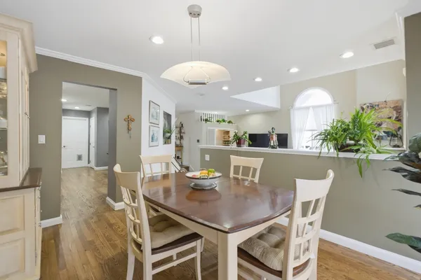 a view of a dining room with furniture and wooden floor