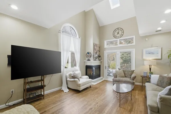 a living room with furniture a fireplace and a flat screen tv