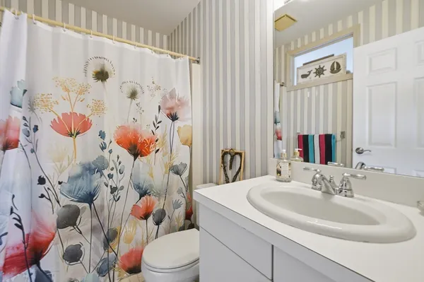 a bathroom with a sink toilet and shower