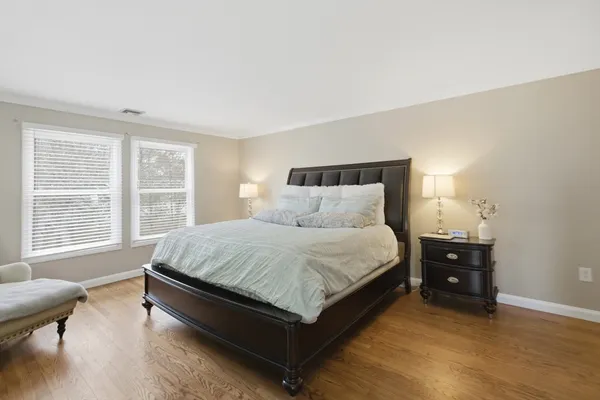 a bed sitting in a bedroom next to a window