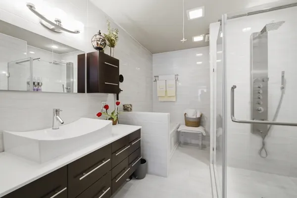 a bathroom with a sink a toilet and shower