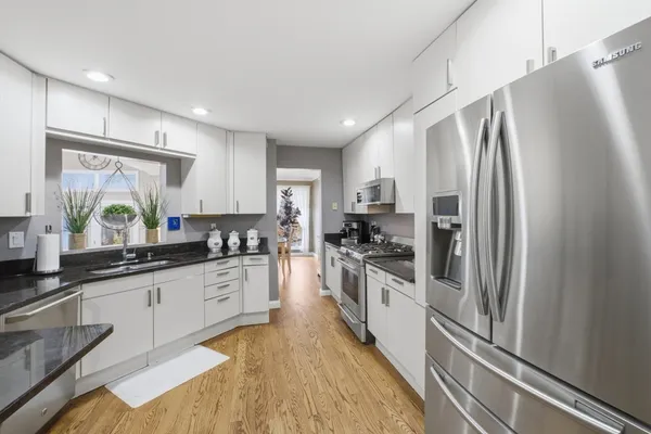 a large kitchen with cabinets and stainless steel appliances