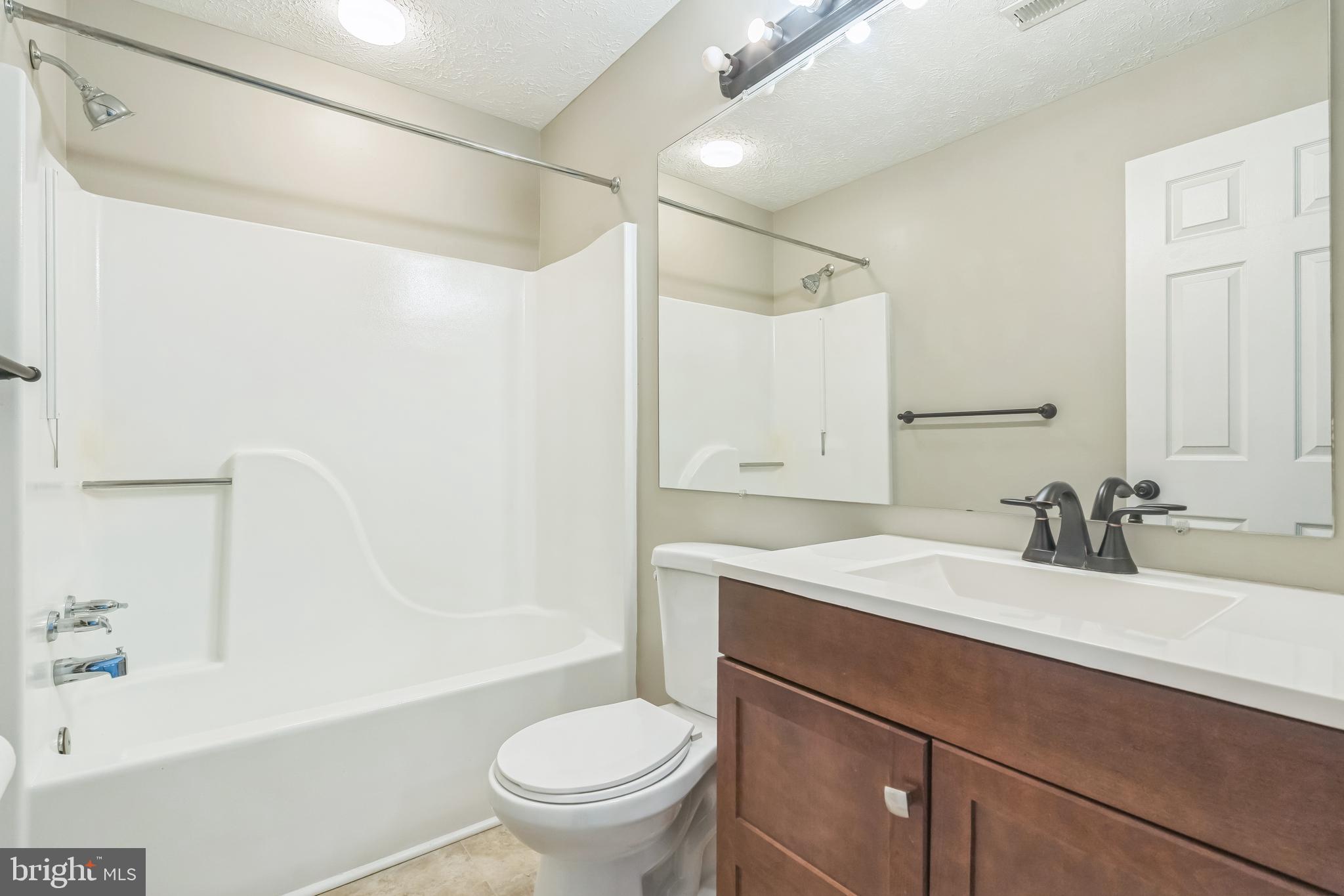 15 Beagle Run, Unit 98 Baltimore, MD 21236 - Photo 13 of 15 a bathroom with a sink toilet vanity and tub