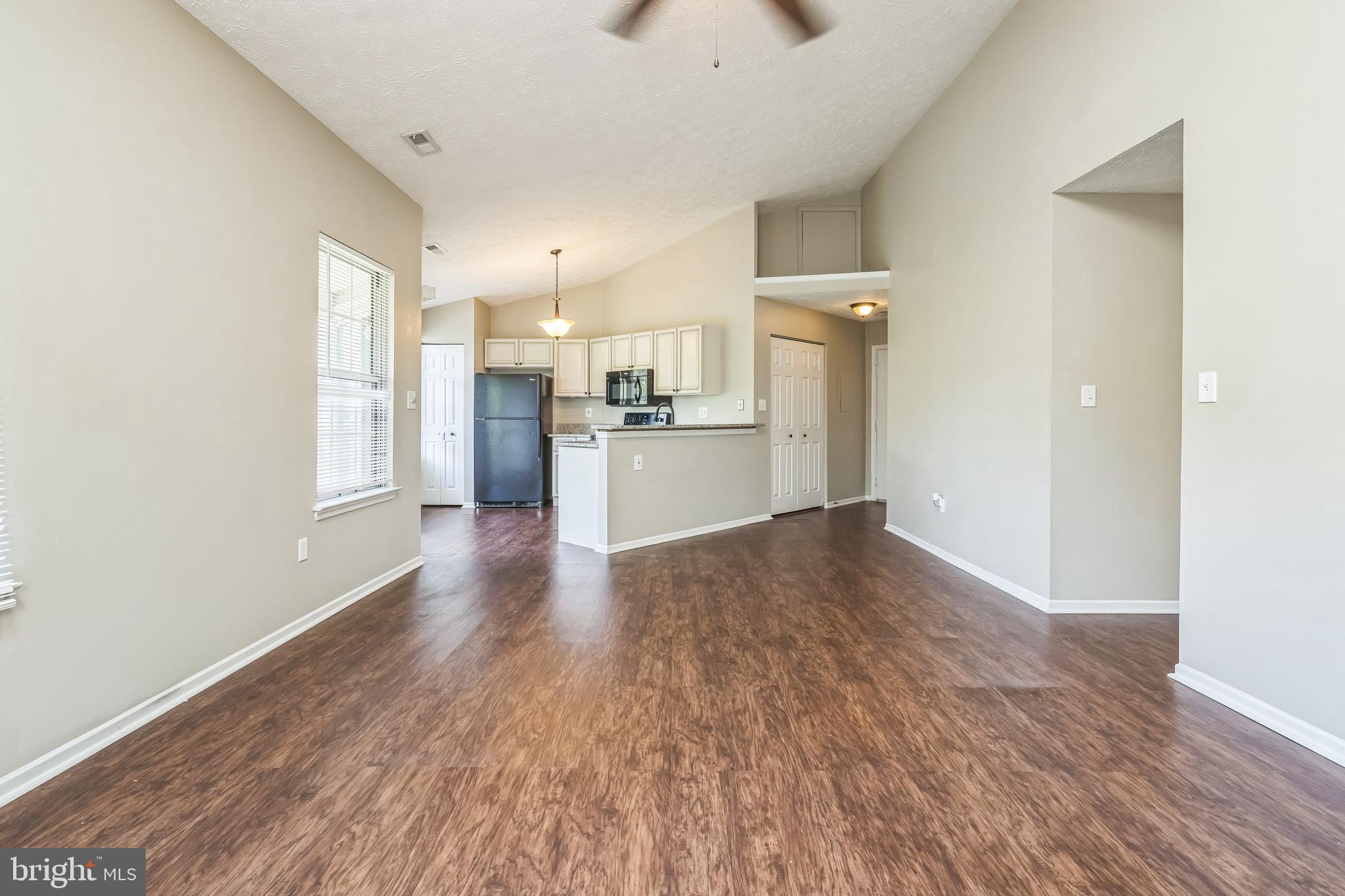 15 Beagle Run, Unit 98 Baltimore, MD 21236 - Photo 4 of 15 a view of a kitchen with a stove cabinets and wooden floor