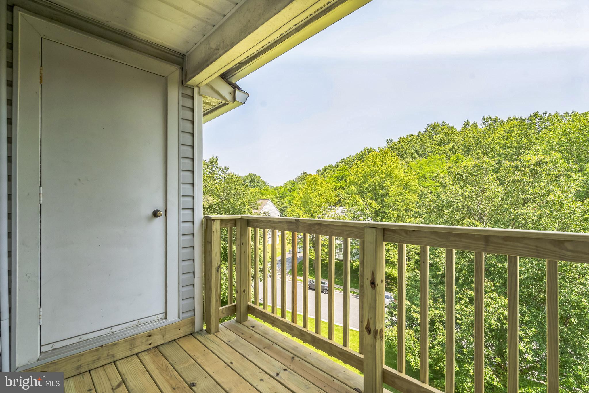 15 Beagle Run, Unit 98 Baltimore, MD 21236 - Photo 7 of 15 a view of a balcony with wooden floor