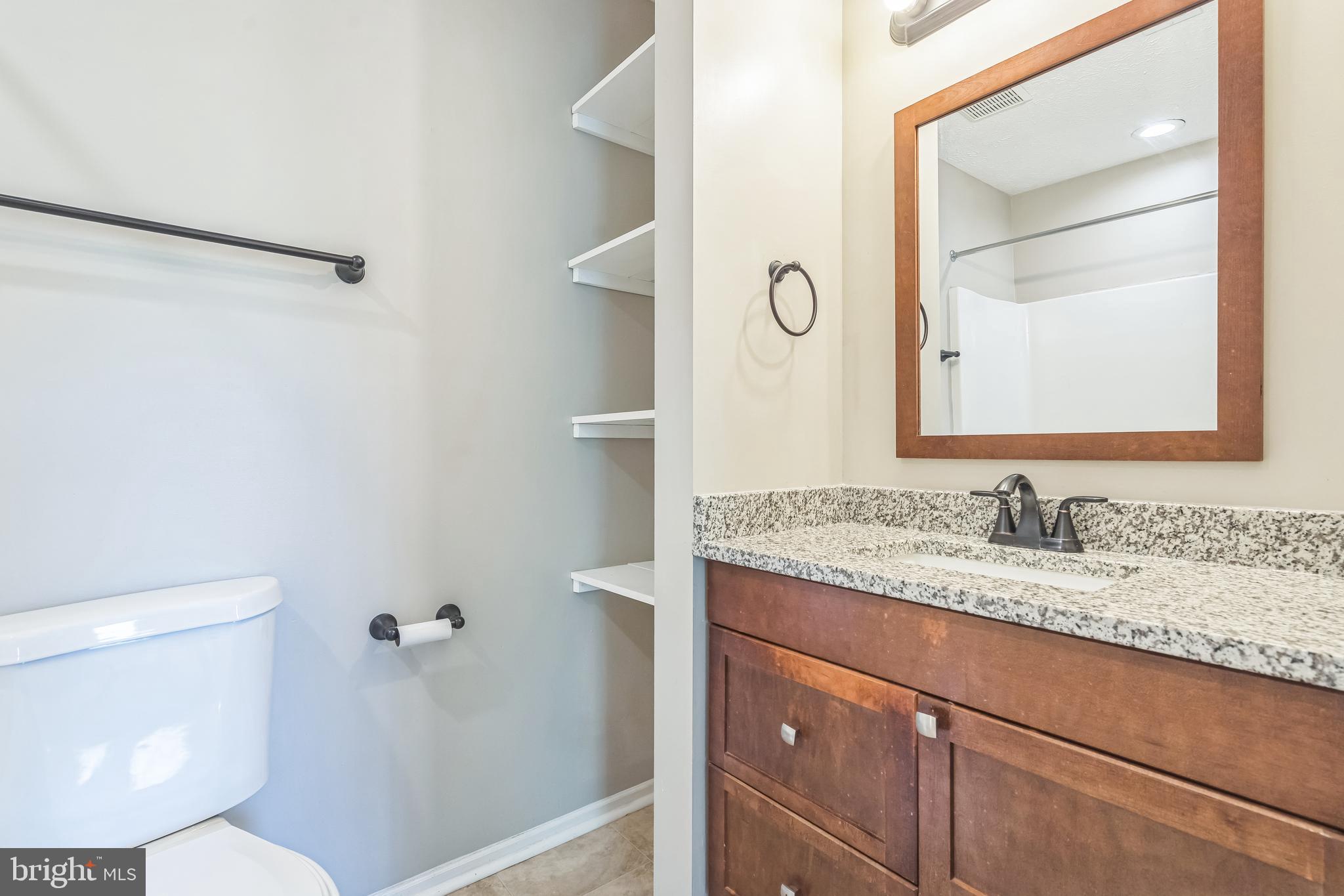 15 Beagle Run, Unit 98 Baltimore, MD 21236 - Photo 10 of 15 a bathroom with a granite countertop sink mirror vanity and toilet