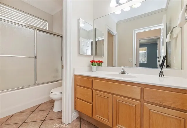 a bathroom with a double vanity sink toilet mirror and shower