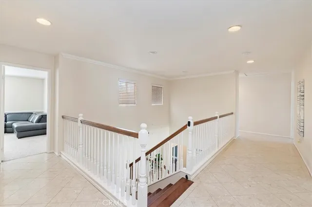 a view of a hallway with a livingroom and stairs