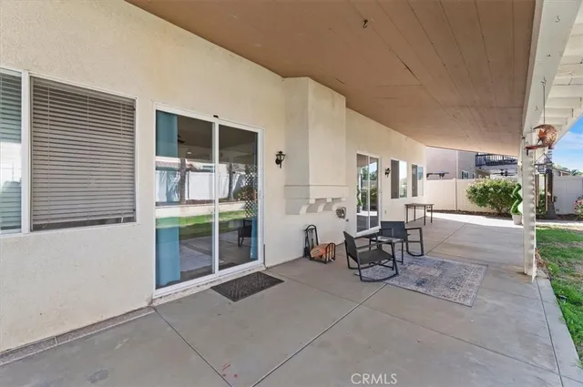 a view of a patio with table and chairs and potted plants