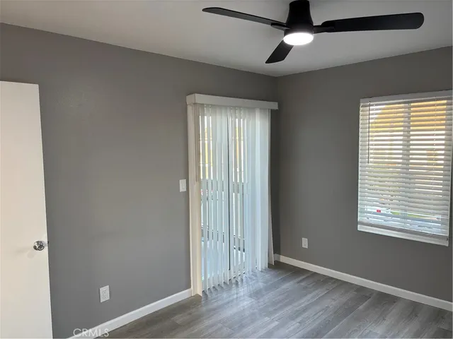 a view of an empty room with window chandelier fan