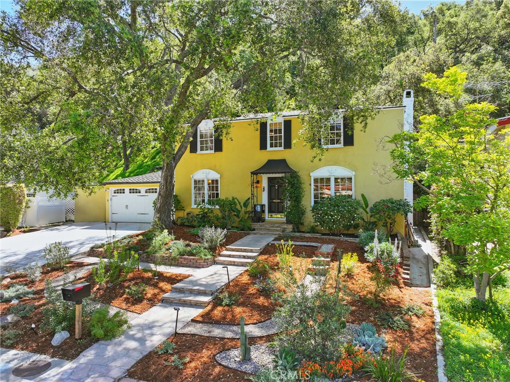 a front view of a house with garden