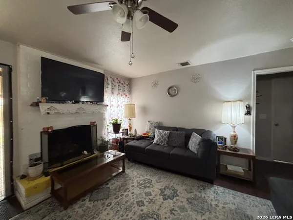 a living room with furniture a flat screen tv and a fireplace