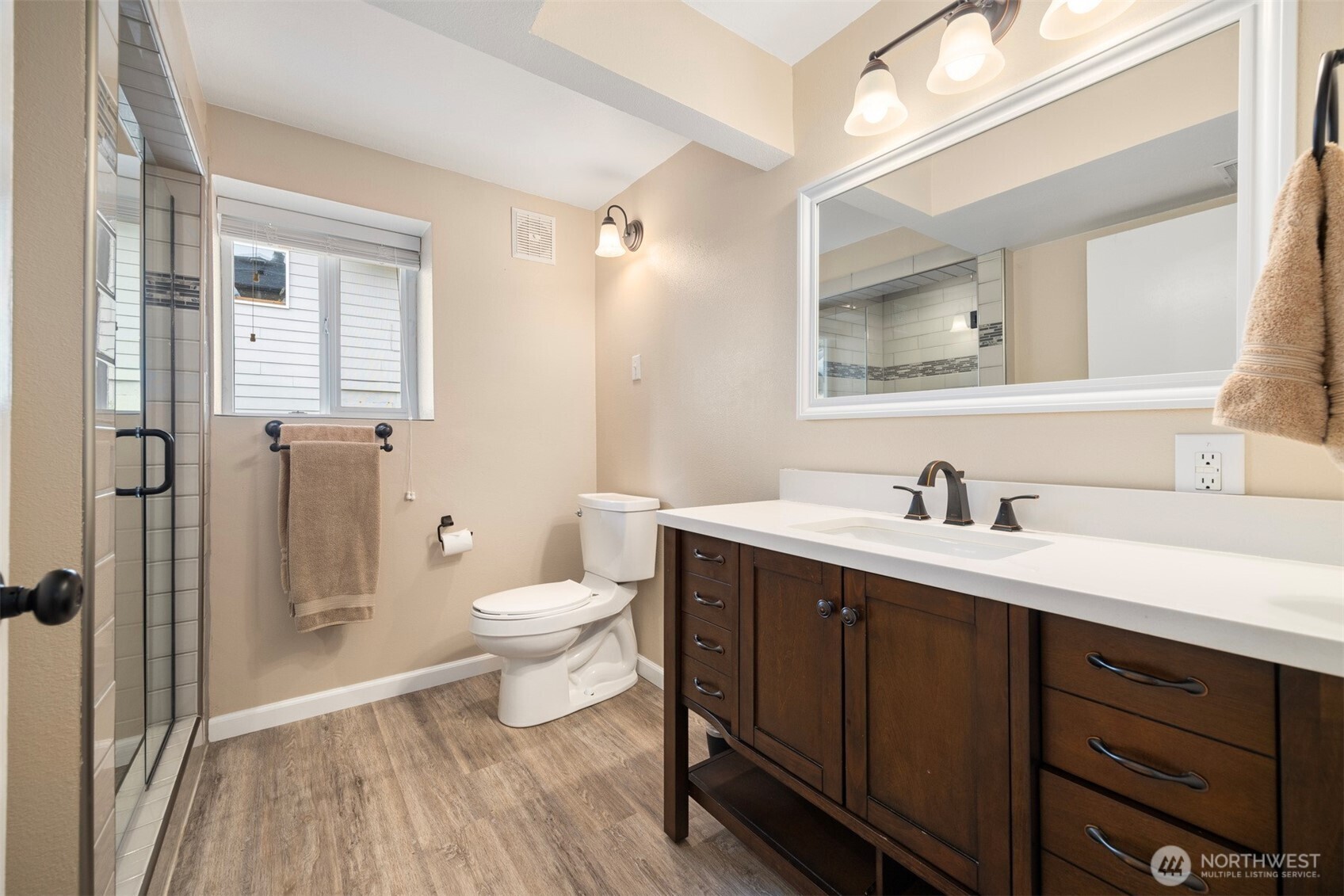 1000 Samish Way Bellingham, WA 98229 - Photo 26 of 40 a bathroom with a toilet a sink a mirror a shower and vanity