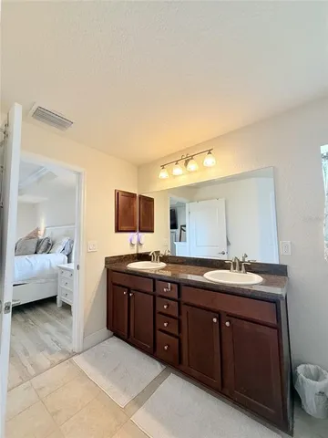 a spacious bathroom with a double vanity sink and mirror