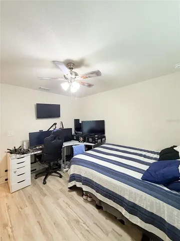a work room with furniture and a ceiling fan