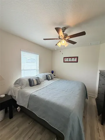 a bedroom with a bed and a ceiling fan