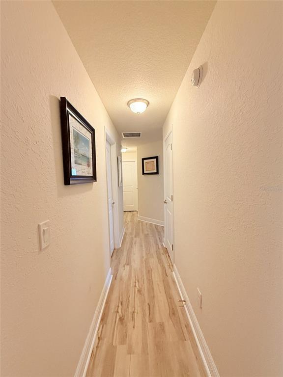186 Northwest 44th Street Ocala, FL 34475 - Photo 26 of 36 a view of a hallway with wooden floor