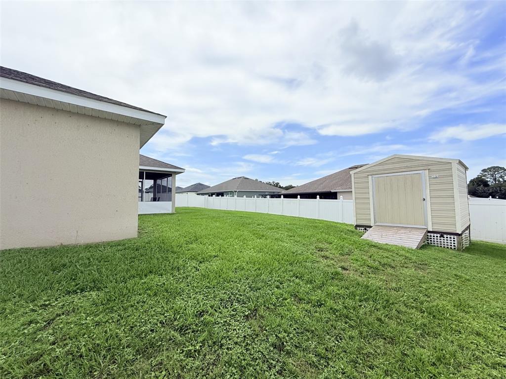 186 Northwest 44th Street Ocala, FL 34475 - Photo 32 of 36 a backyard of a house with lots of green space and garden