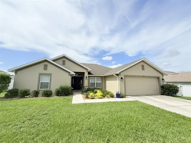 a front view of house with yard and green space