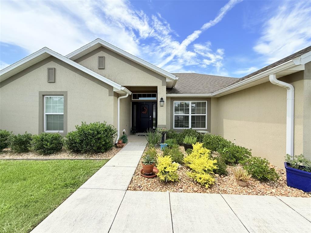 186 Northwest 44th Street Ocala, FL 34475 - Photo 5 of 36 a front view of a house with garden