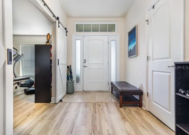 a view of empty room with wooden floor and electronic appliances