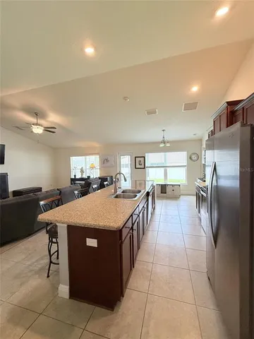 a large kitchen with a large counter top appliances and cabinets
