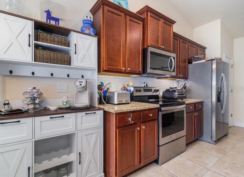 186 Northwest 44th Street Ocala, FL 34475 - Photo 10 of 36 a kitchen with stainless steel appliances granite countertop a stove a sink dishwasher and a refrigerator