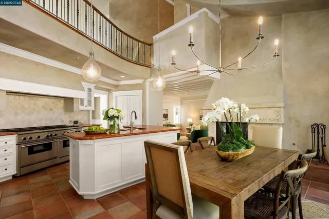 a kitchen with granite countertop a table chairs stove and cabinets