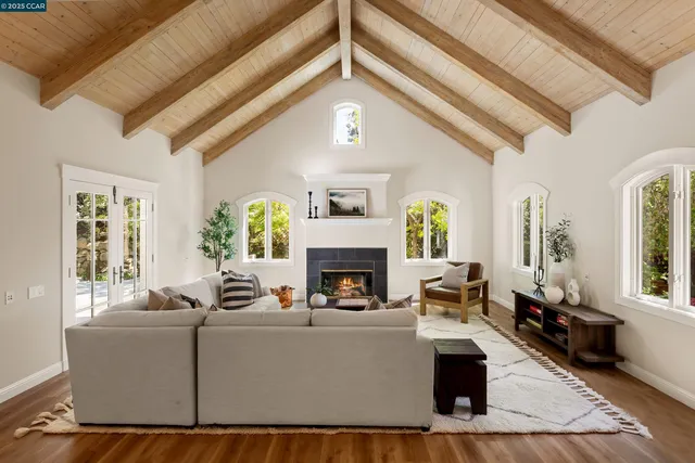 a living room with furniture and large windows