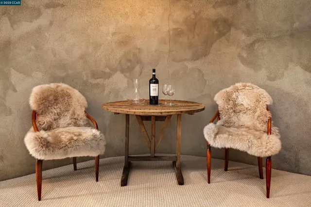 a spacious bedroom with a bed couch and two large window